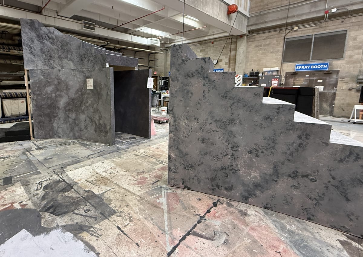 Twelve-foot tall staircase painted to look like stone in a warehouse studio