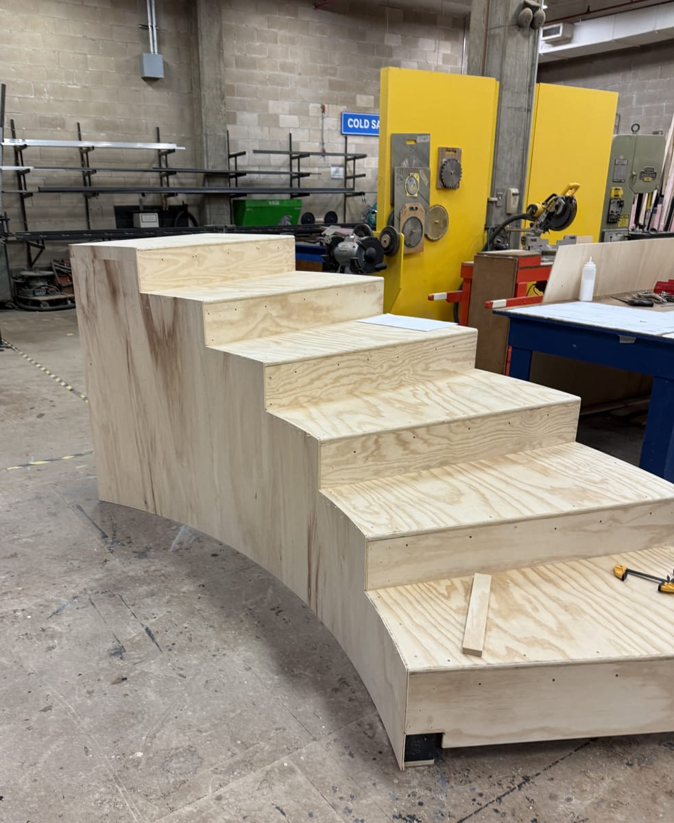 Four-foot tall section of wooden stairs in a workshop