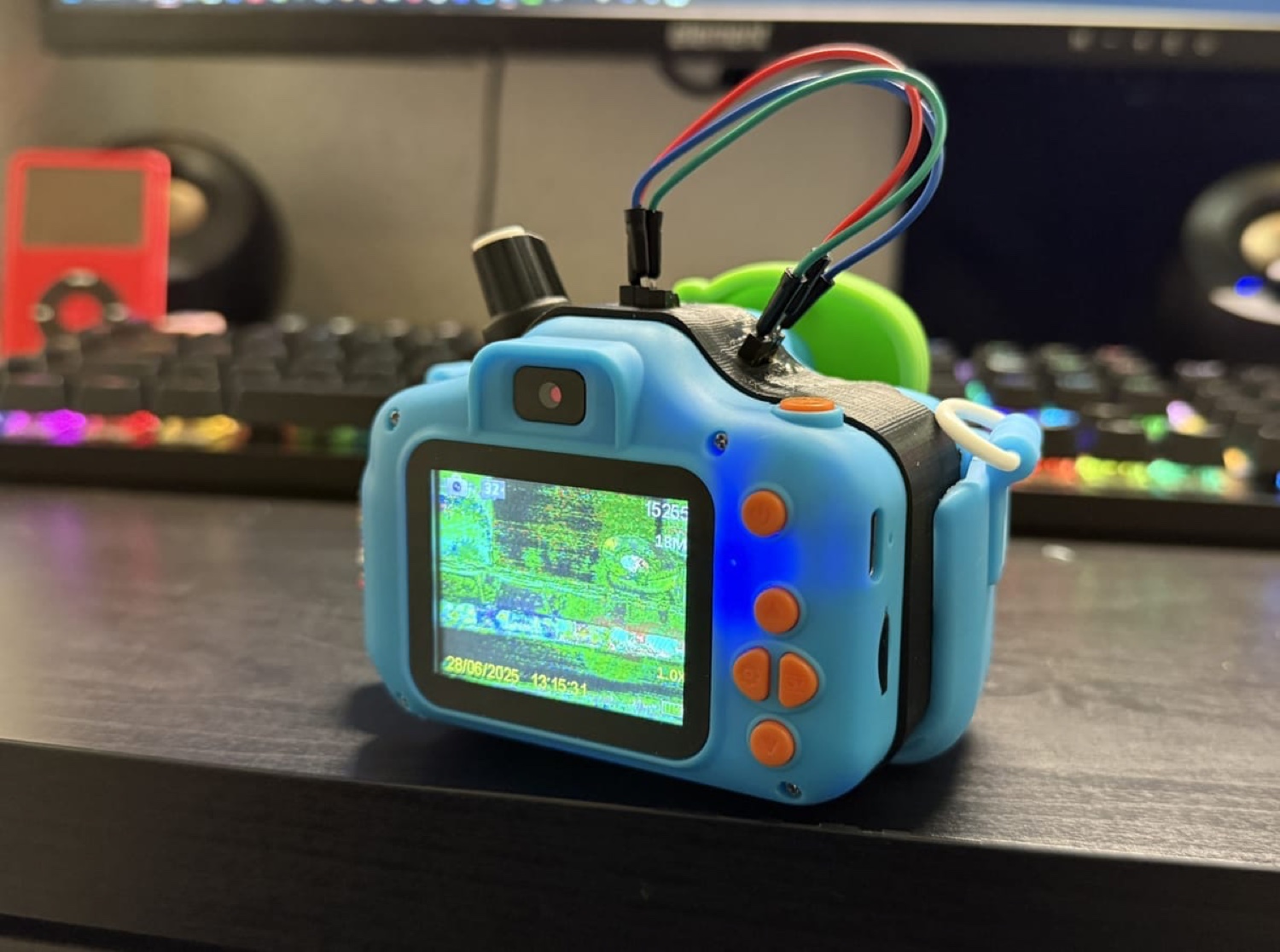 Modified children's camera with exposed wires and a glitched screen