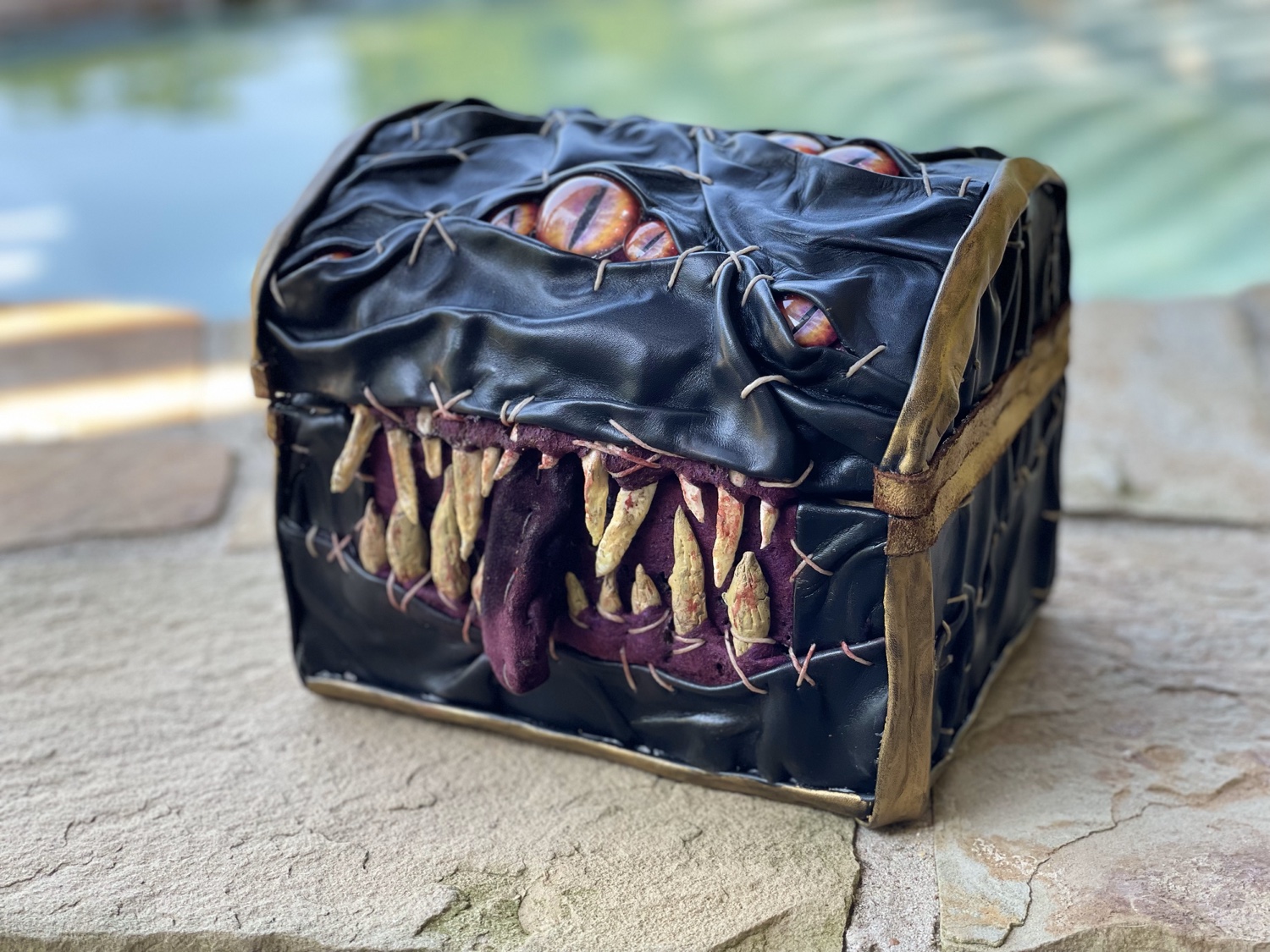 Leather mimic chest sculpture with teeth and eyes