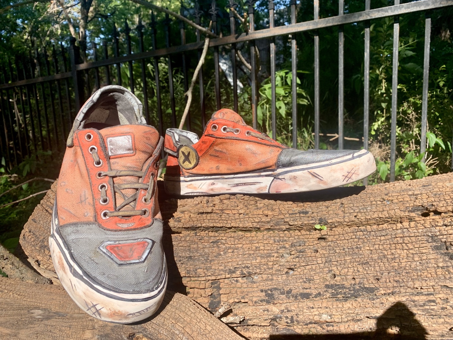 Hand-painted custom sneakers on a weathered plank