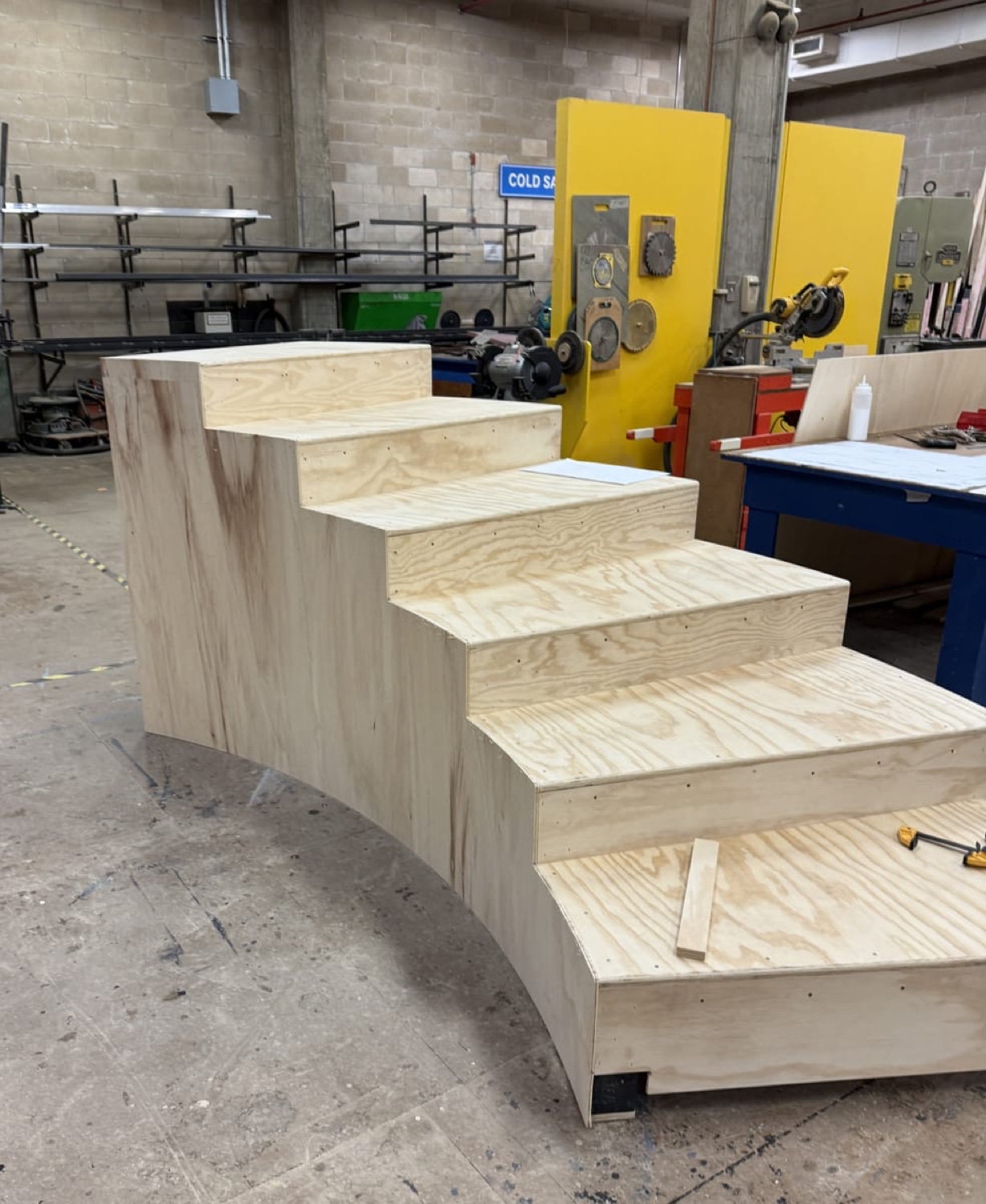 Raw wooden staircase section under construction in a workshop