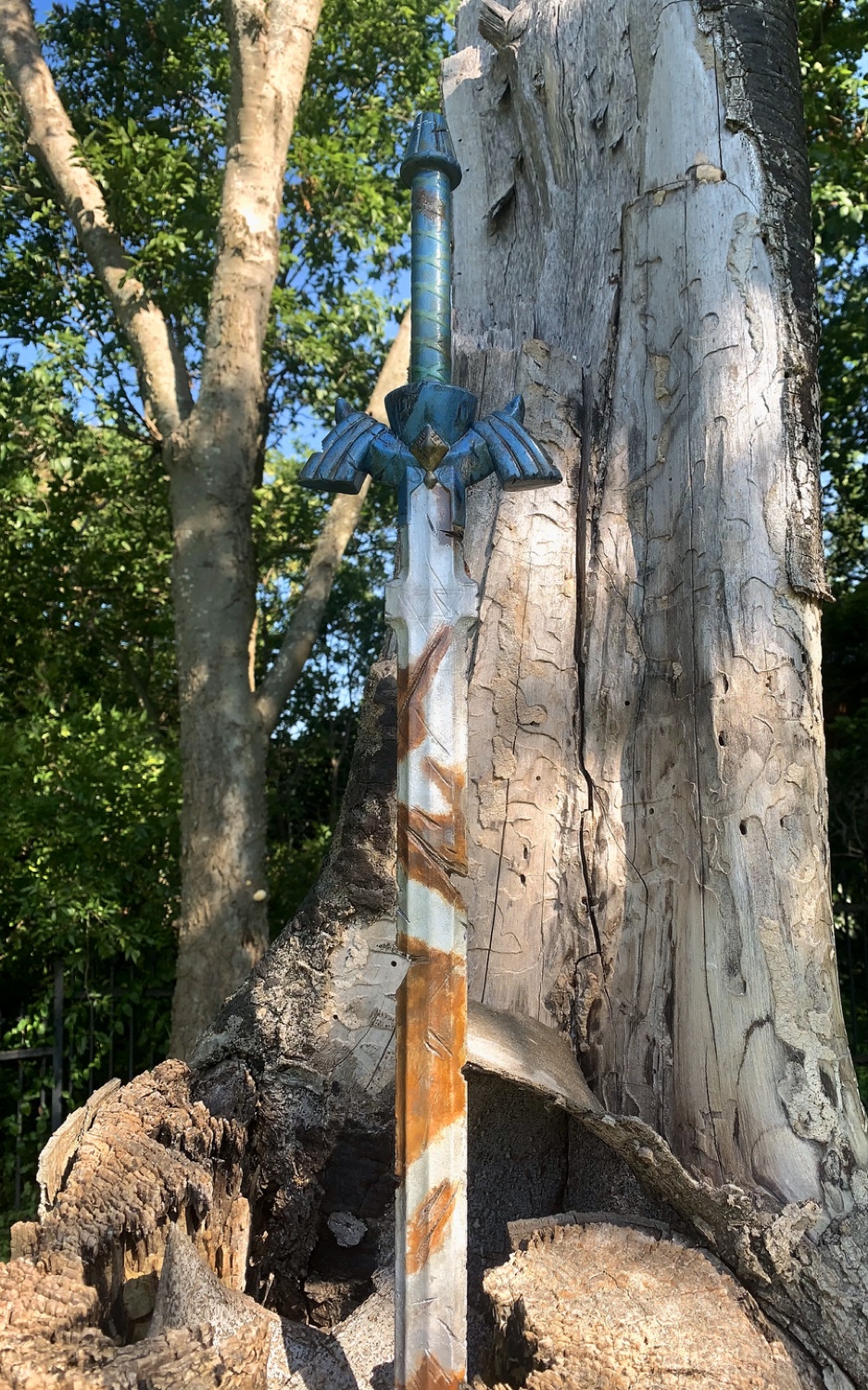 Hand-finished Master Sword replica planted in a tree stump