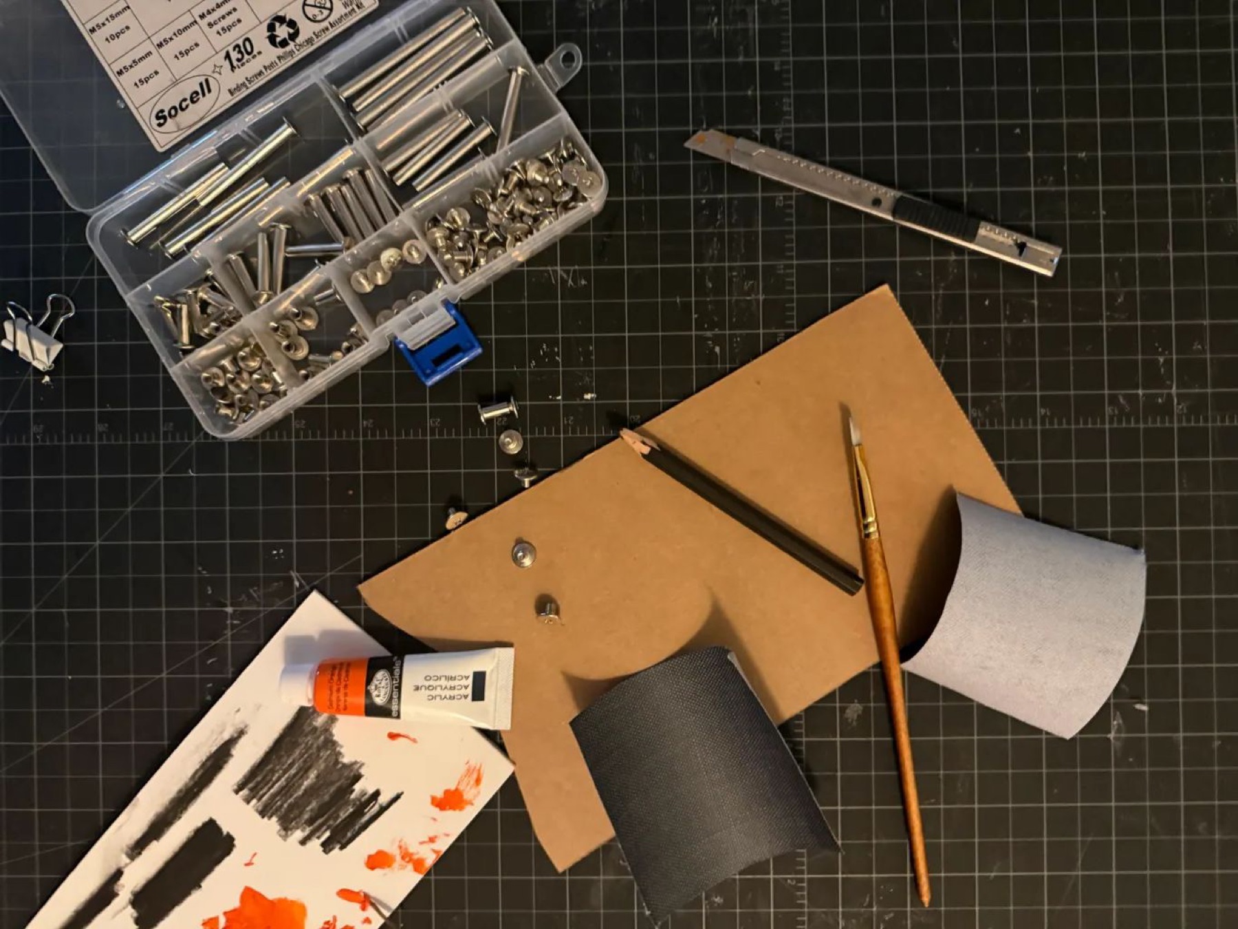 Cover process — charcoal transfer and acrylic paint on grey fabric